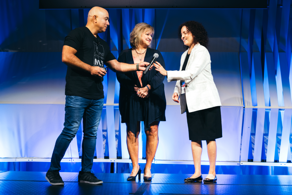 Sarah Davis on stage receiving the Caitlyn Kaufman award at MUS.