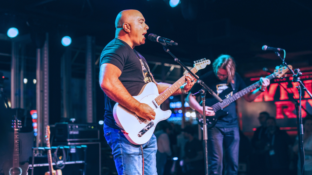 Jad Saliba singing and playing guitar.